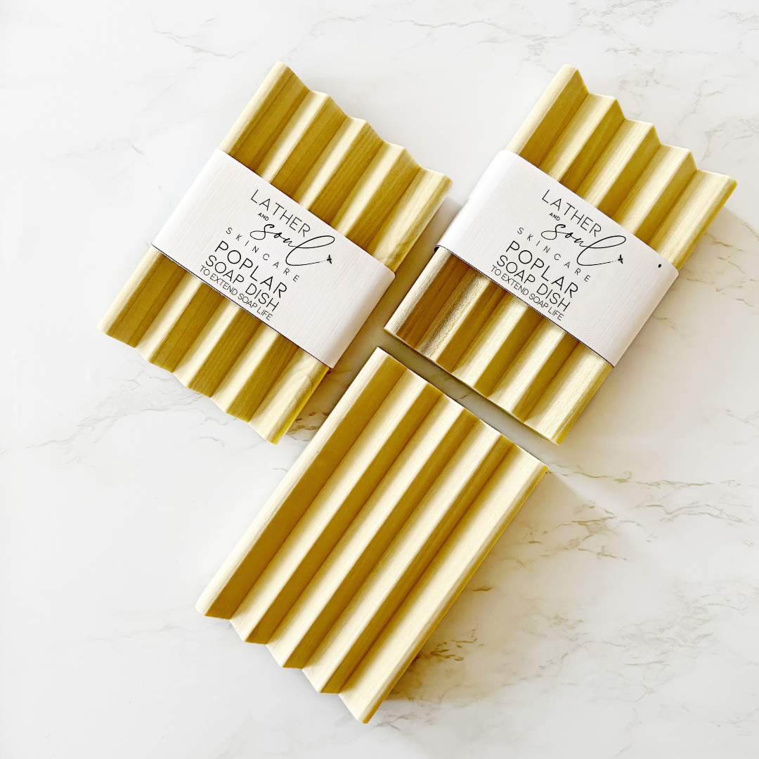 Poplar Wood Soap Dish lays on a marbled white table.