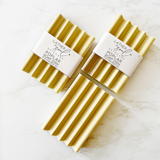 Poplar Wood Soap Dish lays on a marbled white table.