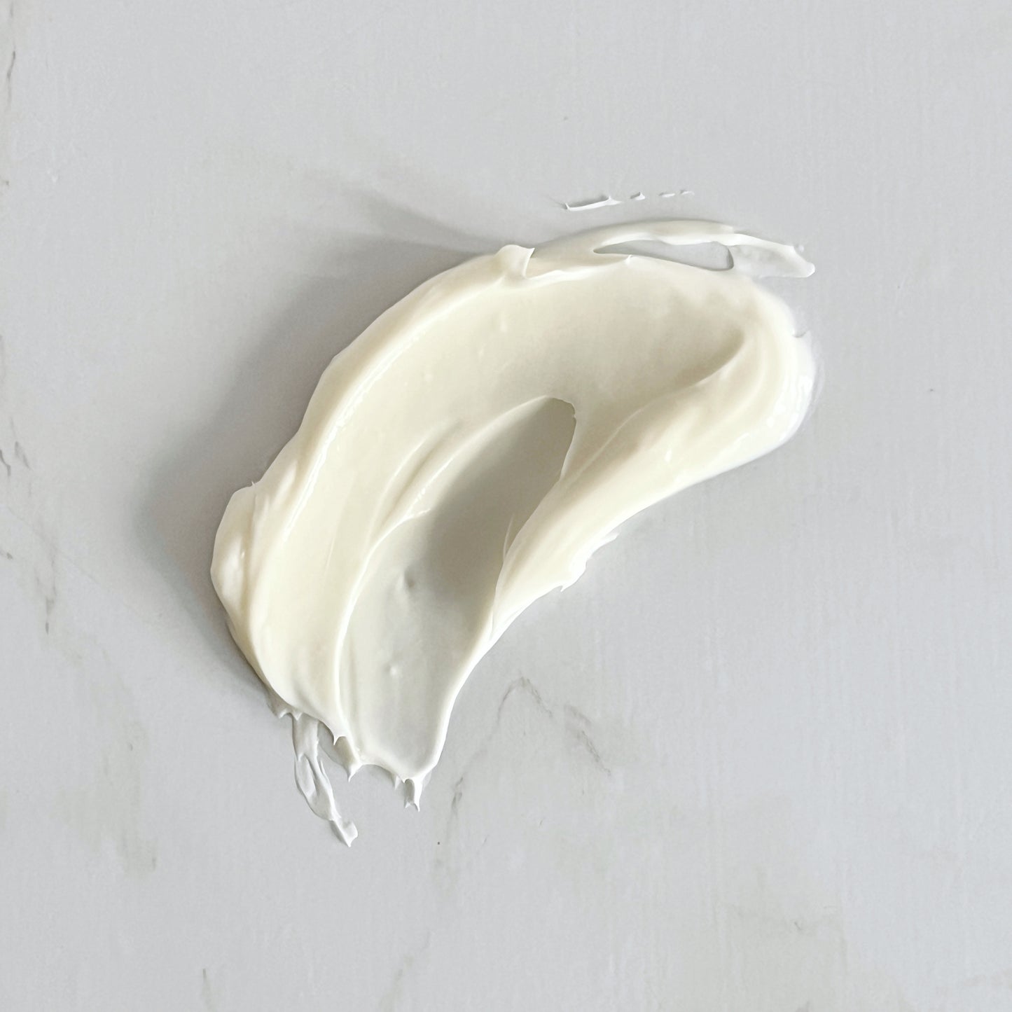 White cream swatch on a light gray background