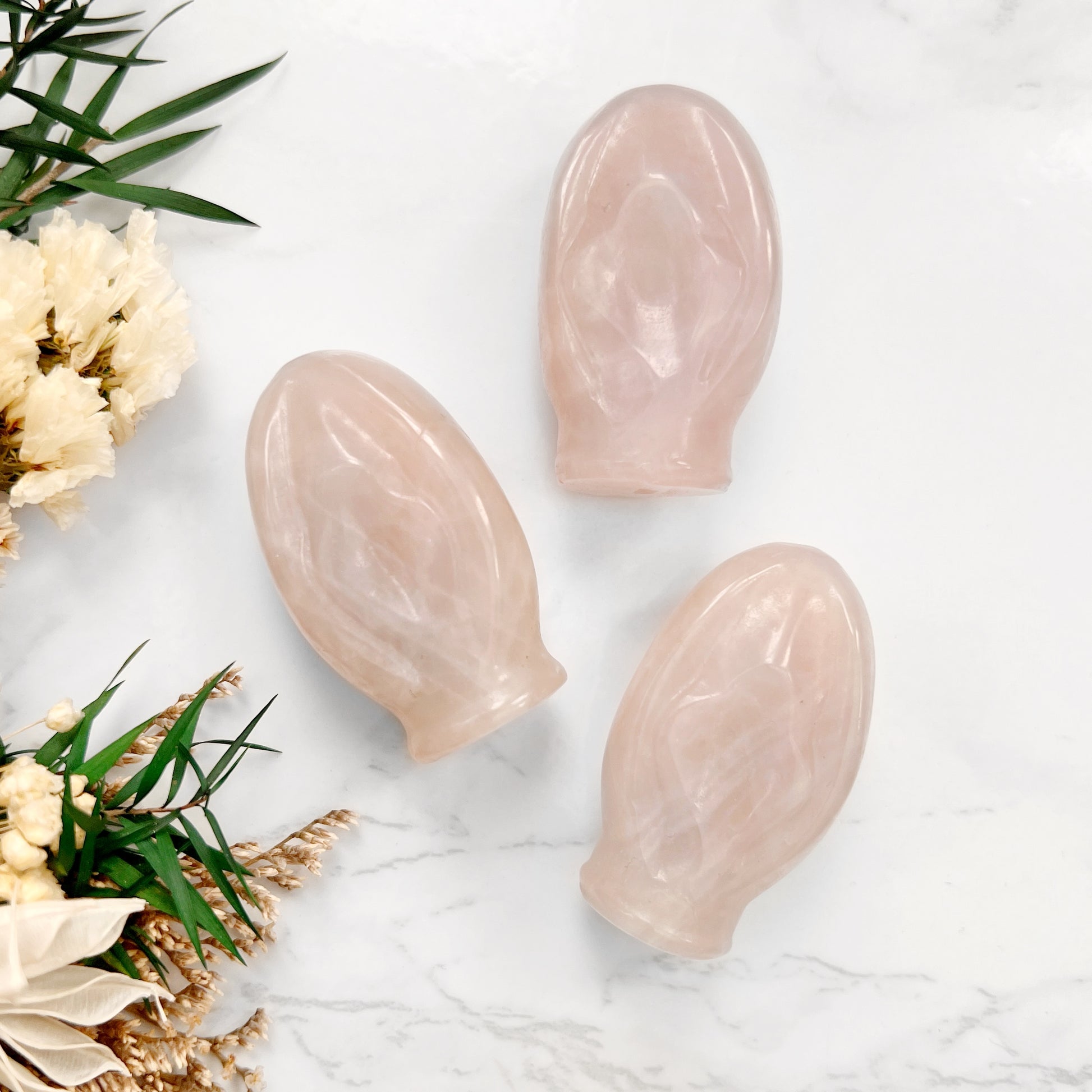 Trio of Love and Harmony: A stunning display of three Rose Quartz crystal vulva shapes, representing the ultimate symbol of unconditional love, compassion, and emotional healing. The gentle pink hues of these gemstones radiate harmony, forgiveness, and empathy.