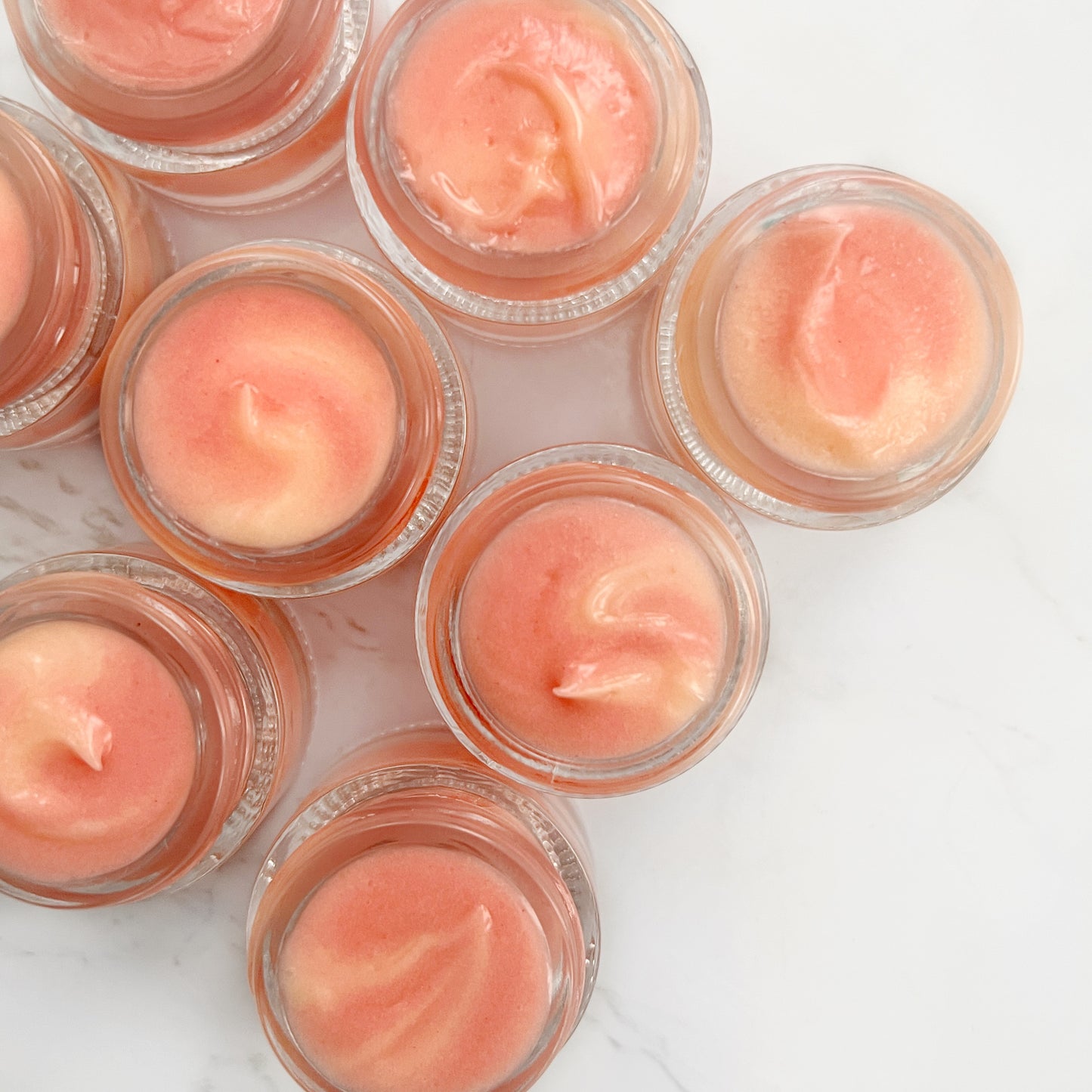 Batch of Hydrating Lip Masques: A diverse assortment of our nourishing lip treatment jars arranged in a captivating flat lay, showcasing the variety and quality of our lip-enhancing formula.
