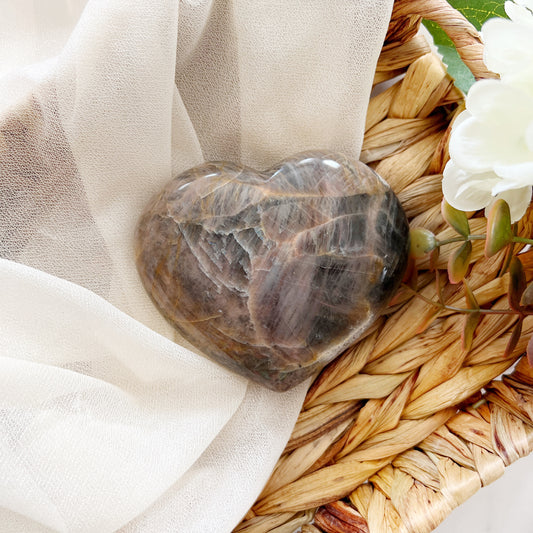Black moonstone heart displayed in basket.