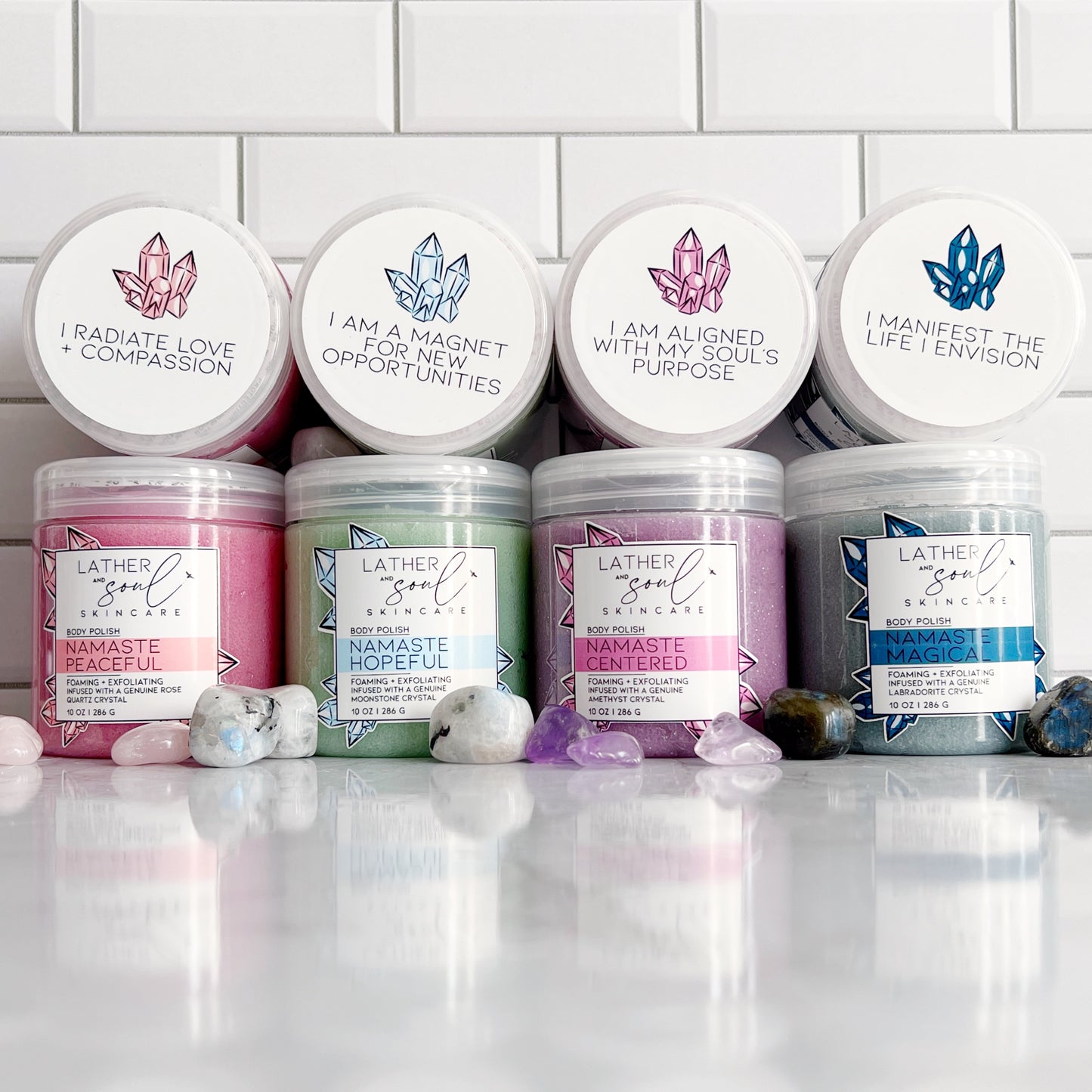 An assortment of crystal infused body polish from Lather + Soul