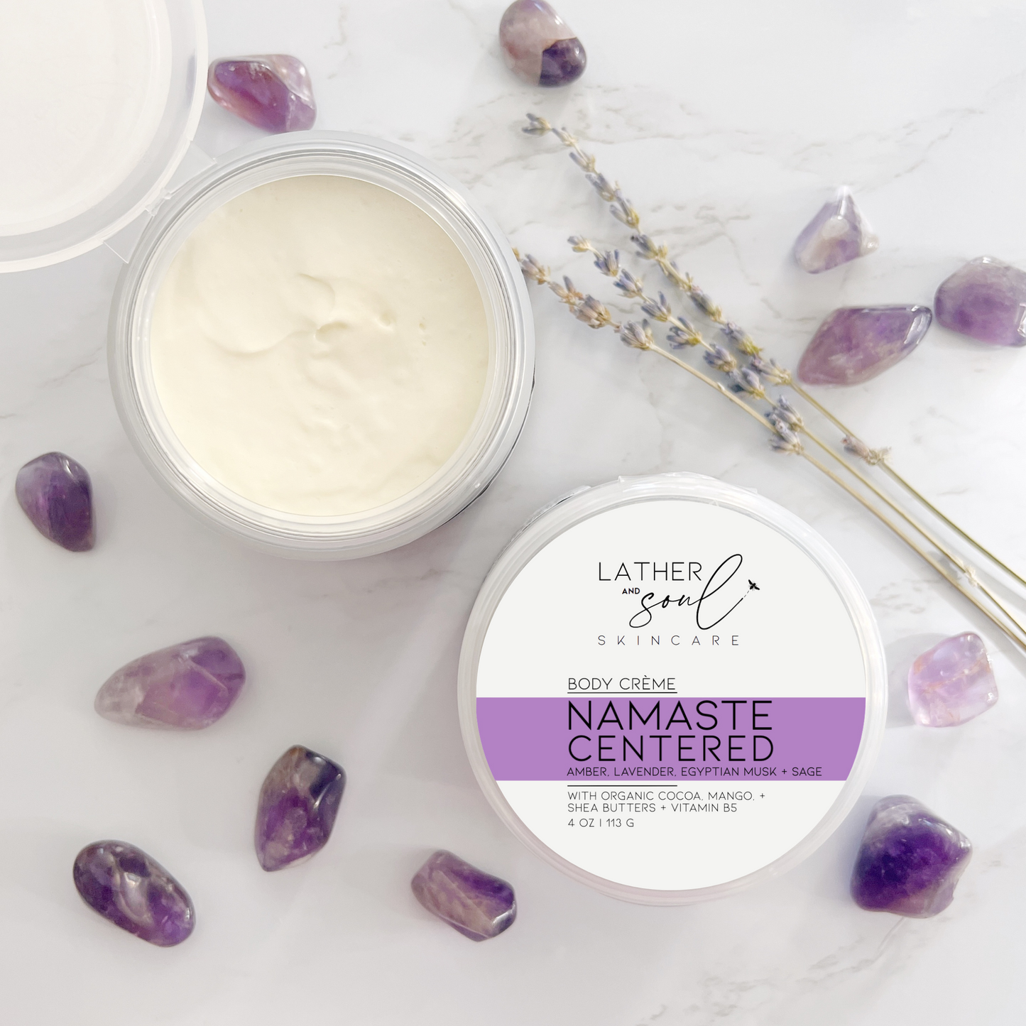 Luxurious body crème by Lather and Soul Skincare, on white table with amethysts, in Namaste Centered scent.