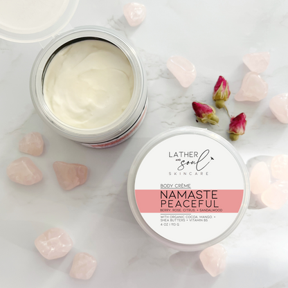 Namaste Peaceful organic body crème by Lather and Soul Skincare surrounded by rose quartz crystals on white table