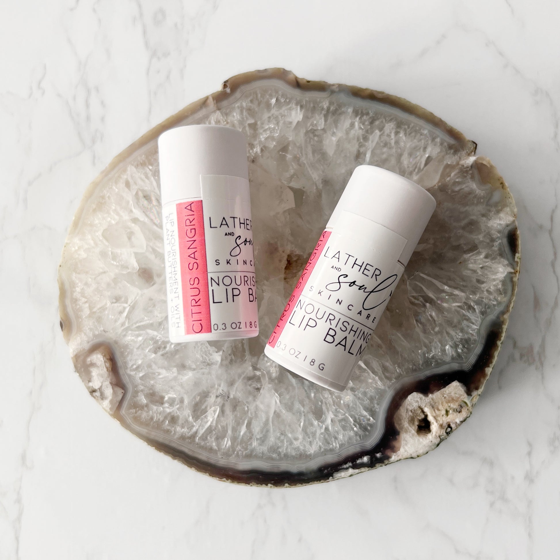 Best selling organic lip balm by Lather + Soul in Citrus Sangria flavor and in eco friendly paperboard tube