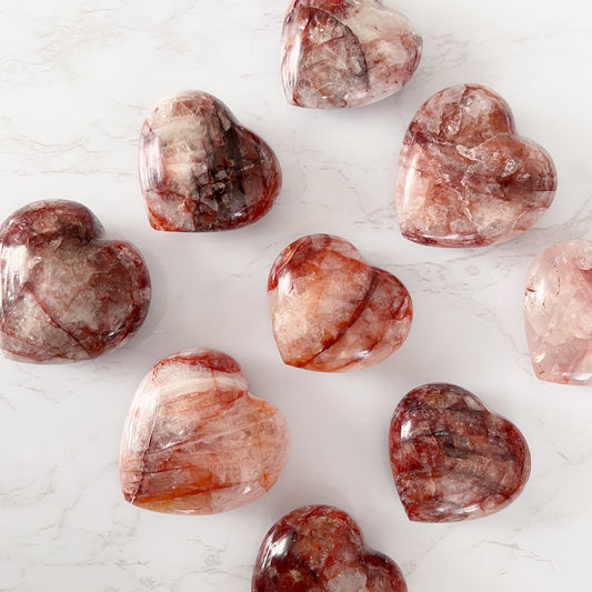 A variety of Red Healer Quartz in heart shapes, also referred to as Fire Quartz