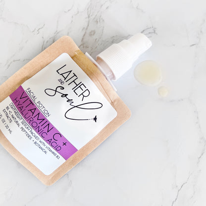 Facial potion with vitamin C and hyaluronic acid on a marble surface