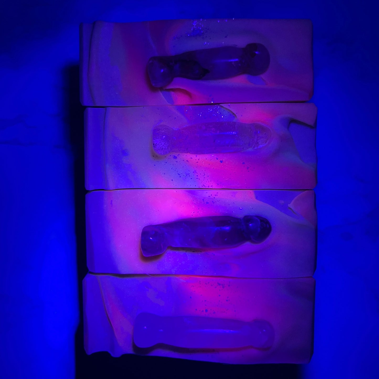 Crystal soap with crystal penises glowing under UV light