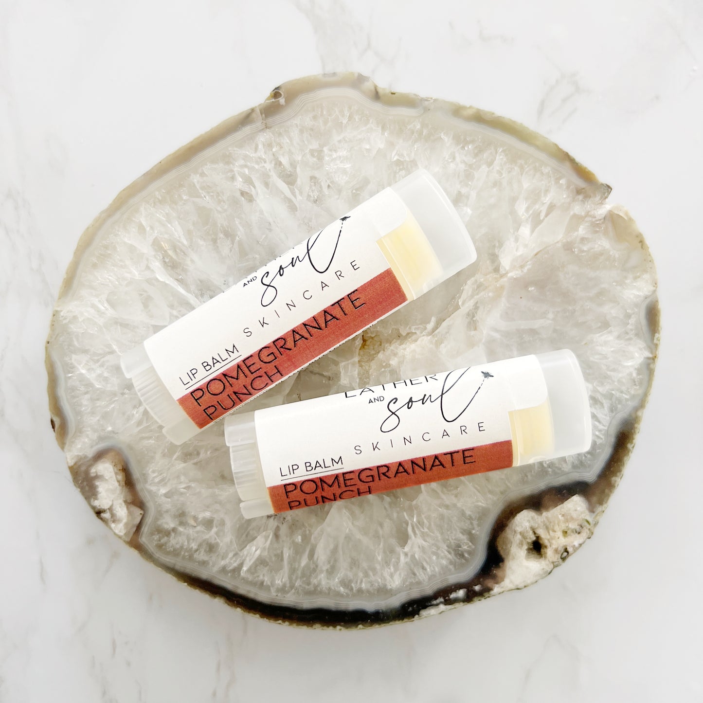 Organic lip balm by Lather + Soul, in pomegranate punch flavor.