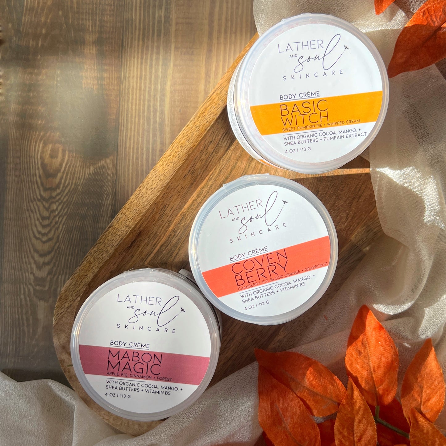 Fall inspired body crèmes from Lather and Soul, on wooden tray.