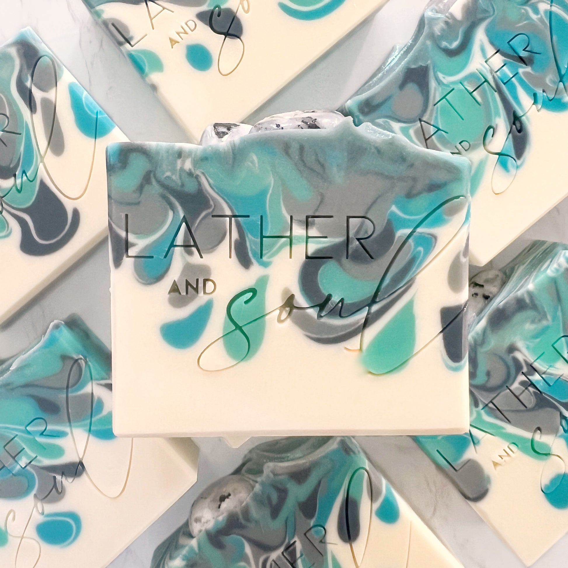 Handmade soaps with genuine rainbow moonstone and swirls of blues and teals.
