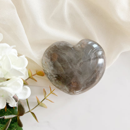 Black moonstone heart thought to help calm emotions, reduce stress, and bring a sense of tranquility and emotional grounding.